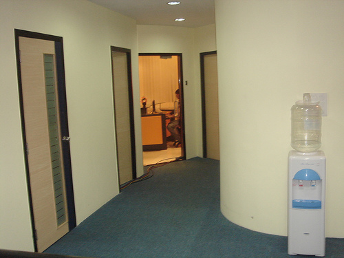 THE AISLE. FROM LEFT, THE FIRST ROOM IS DIRECTOR'S CABIN, NEXT IS UPS ROOM, THIRD IS RECEPTION AND FOURTH IS CONFERENCE ROOM.